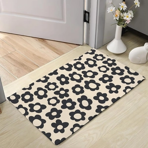 Detail of minimalist floral diatom mud mat on wood floor with cozy home decor