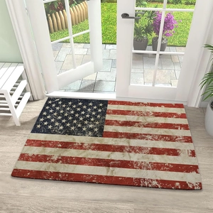 Macro detail of American flag door mat showing vintage texture on a white porch floor