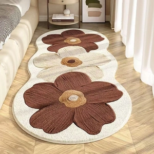 Floral bedside rug with wavy edges and brown cream flower pattern for home decor