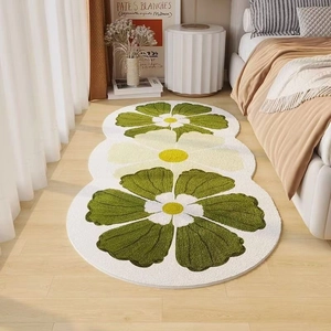 Detail of floral runner rug with green and white flower design on light wood floor