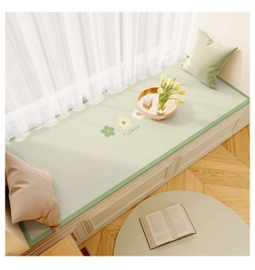 Detail of light green leather bay window mat with flower patterns and dark green piping