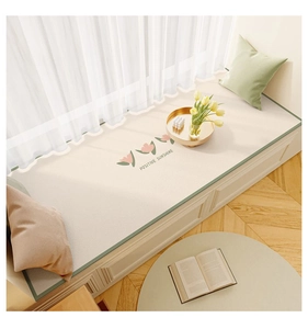 Detail of waterproof cream leather bay window mat with floral print and green piping edge