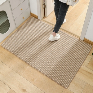 Brown woven pineapple pattern entry mat with non-slip texture on light wood floor
