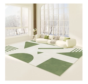 Detail of modern geometric rug featuring cream and green patterns with refined edges