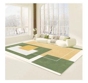 Detail of green and yellow geometric pattern rug in a modern living room setting