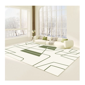 Close-up of minimalist cream area rug with forest green geometric patterns and lines