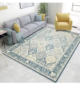 Detail of bohemian Persian style rug with blue and beige floral patterns in a living room