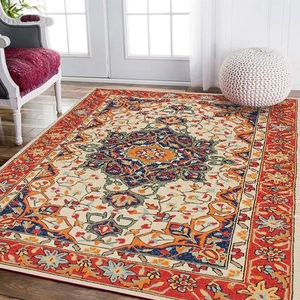 Bohemian Persian rug with red mandala pattern on wood floor with white armchair