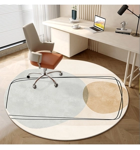 Detail of round abstract rug with grey-blue and mustard geometric patterns in office setting