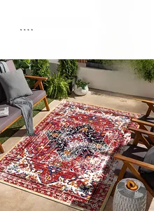 Detailed close-up of a red bohemian Persian rug with geometric patterns on a patio