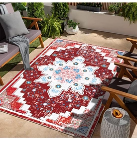 Detail of red Persian style rug showing vintage geometric mandala patterns and weathered texture