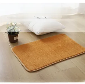 Detail of a brown coral fleece bathroom mat with vertical stripes on a light wood floor