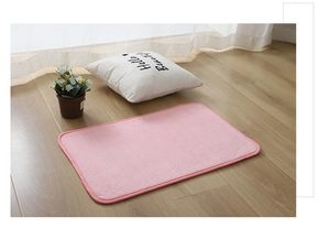 Close-up of pink embossed coral velvet bath mat texture with non-slip backing