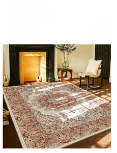 Detail of Persian style rug featuring floral patterns on a dark wood floor in a living room