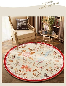 Detail of vintage floral round rug featuring birds and red geometric border trim