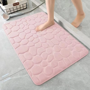 Pink embossed pebble coral fleece bath mat with non-slip texture for bathroom