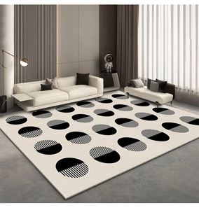 Modern geometric area rug with black dots pattern in a minimalist living room setting