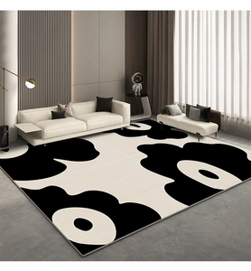 Macro shot of modern black and white floral rug with high-density stitching in a living room