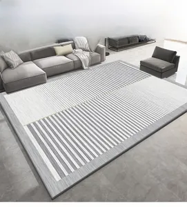 Détail d'un tapis géométrique moderne gris et blanc montrant la texture fine des fibres