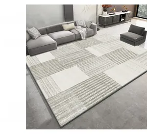 Vue détaillée d'un tapis géométrique gris et beige dans un salon au style moderne épuré