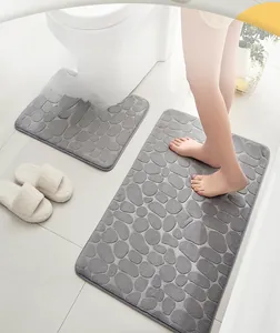 Macro detail of grey cobblestone embossed coral fleece bathroom rug set with non-slip backing