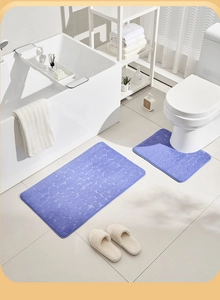 Detailed view of purple pebble embossed coral fleece bath mat set in modern bathroom