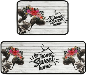 Detail of kitchen mat set with cow pattern, floral wreath and home sweet home text