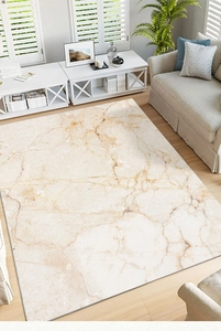 Detail of modern marble pattern area rug with golden accents and high-density stitched edges