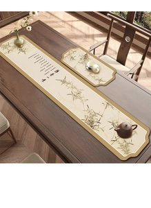 Macro view of Chinese zen style tea mat with ink bamboo pattern and calligraphy on fabric