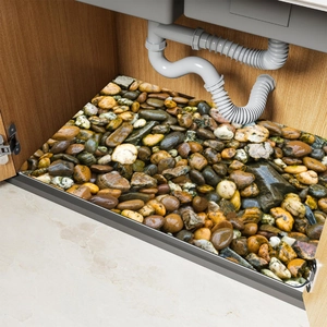 Detailed view of waterproof pebble pattern mat used as kitchen sink cabinet liner