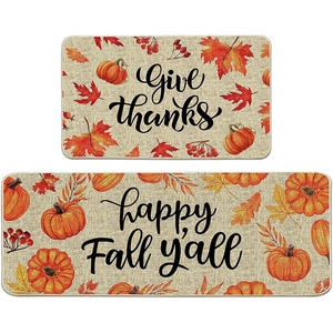 Detail of harvest kitchen mat set with pumpkins, maple leaves, and Give Thanks text