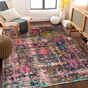 Detail of bohemian rug with vintage floral patterns and rich distressed dye textures