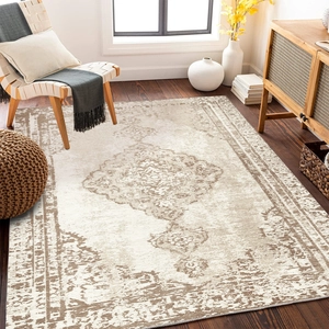 Detail of bohemian vintage carpet medallion pattern on dark wood floor with chair