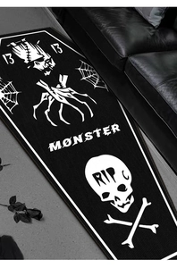 Detailed texture of coffin-shaped Gothic rug featuring skull and spider web motifs