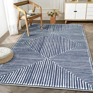 Modern geometric area rug with blue radial lines on wood floor in a living room