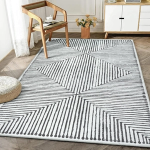 Close-up of gray and white geometric maze lines on a modern minimalist rug surface