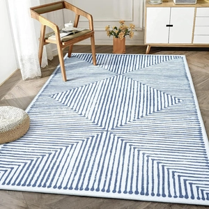 Close-up of modern geometric blue lines on white carpet with neat edge stitching detail