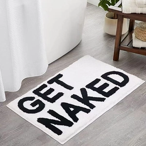 Plush minimalist Get Naked bath mat with black letters on white for bathroom decor