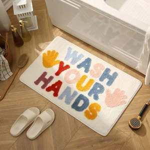 Thick non-slip letter bathroom mat with colorful Wash Your Hands slogan on cream rug