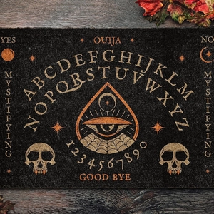 Retro Ouija board halloween door mat with sun and moon pattern on wooden floor