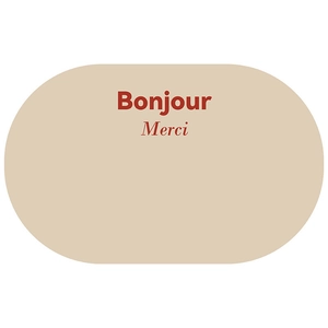 Detailed view of beige oval bathroom mat with Bonjour and Merci printed text