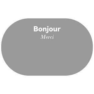Detail of grey oval bath mat featuring Bonjour and Merci text on a soft surface