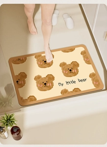 Detail view of absorbent bath mat featuring a cute cartoon bear and My Little Bear text
