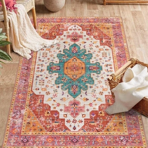 Top view of a bohemian rug with teal geometric patterns and rustic floral borders