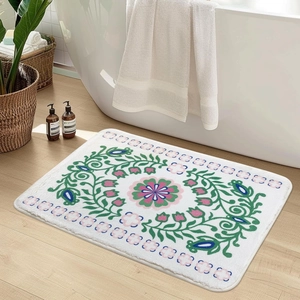 Detailed view of plush floral bathroom mat with intricate ethnic patterns near bathtub