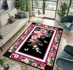 Close-up of vintage floral rug with pink peonies and butterflies on black background