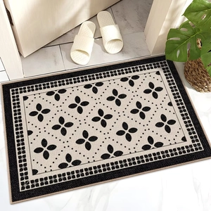 Detail showing the floral pattern and textured border of a non-slip indoor floor mat