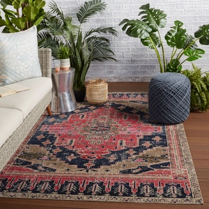 Macro detail of Bohemian area rug with distressed oriental medallion pattern on wood floor