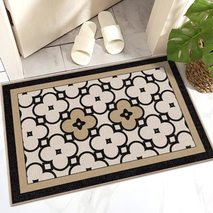 Detailed texture of non-slip entryway mat with beige and khaki clover geometric pattern