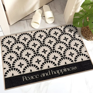 Detail of mandala patterned door mat with Peace and Happiness text in home entryway
